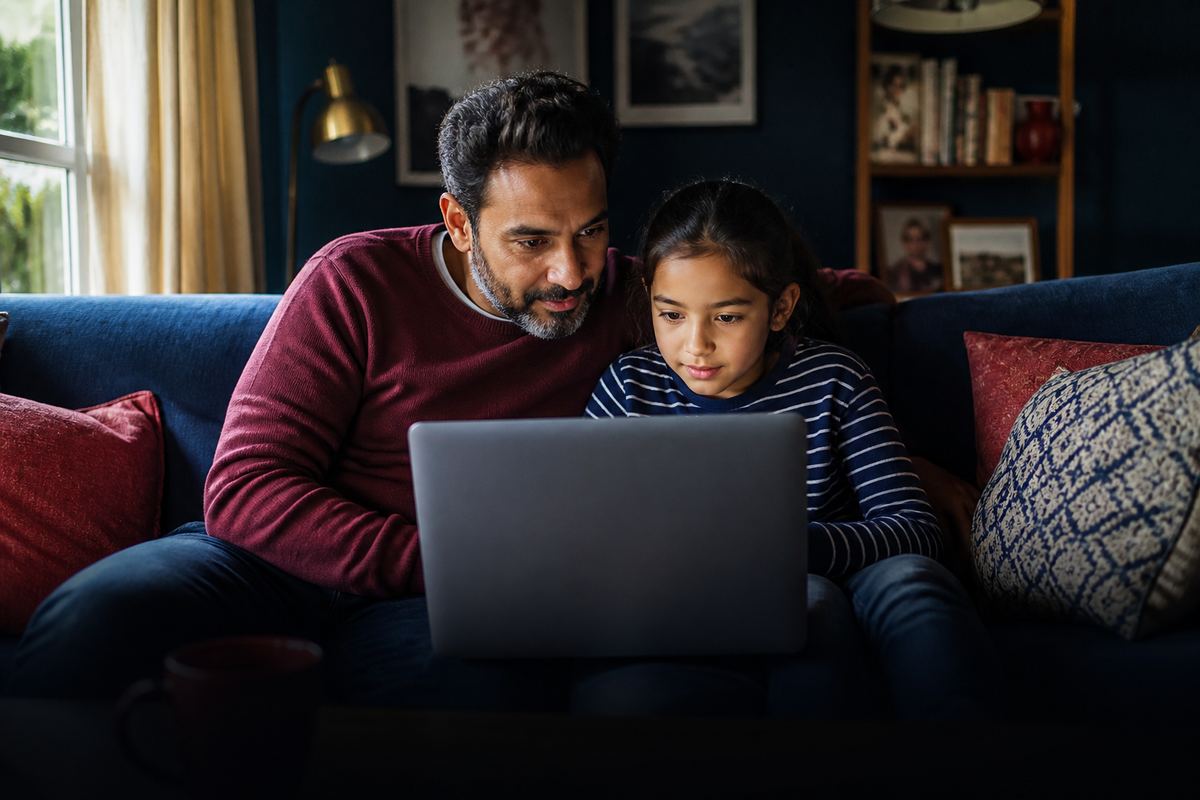 Parent and child looking at a laptop together