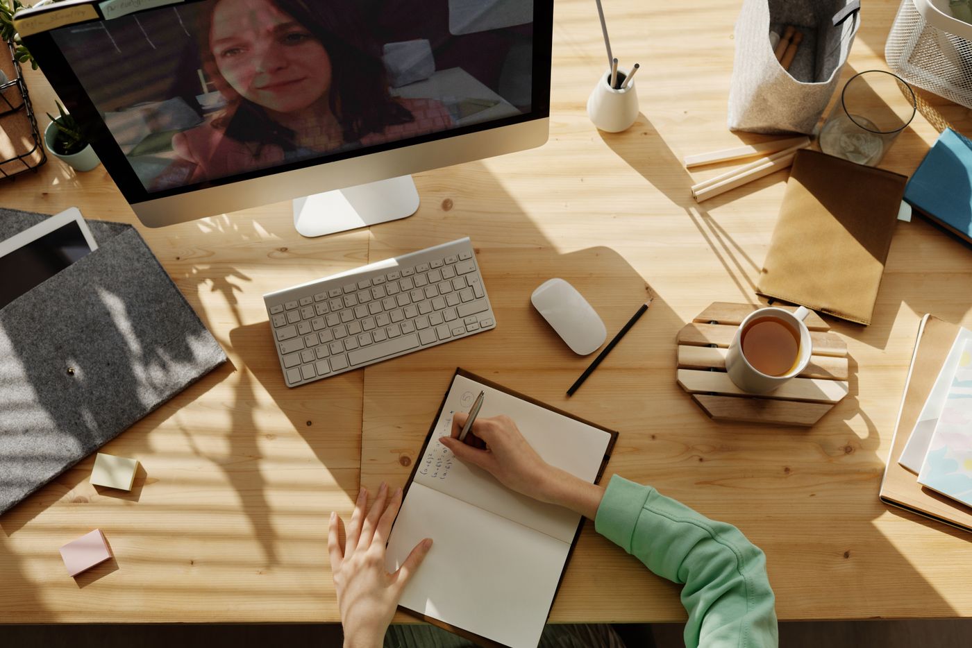Someone using a laptop at a table. Photo on Pexels.